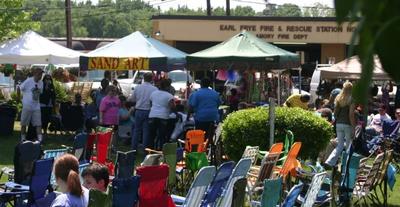 crowd of people at a festival with food trucks and tents