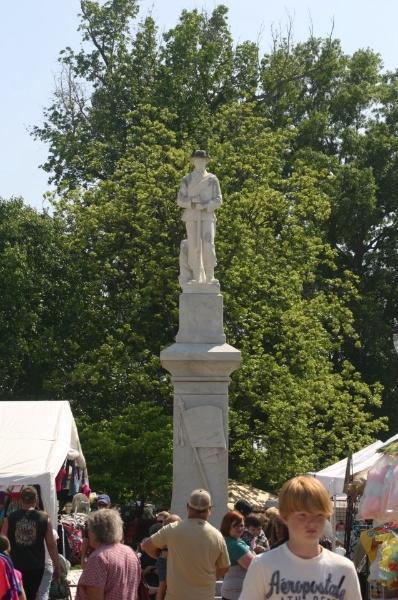 Statue on a riser with people around