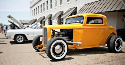yellow and white antique cars on the street
